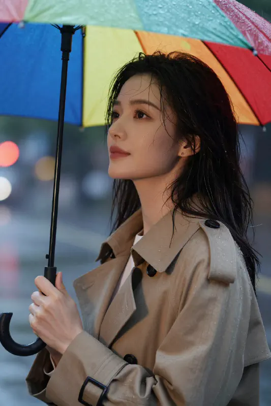 Serene Woman in the Rain with Colorful Umbrella