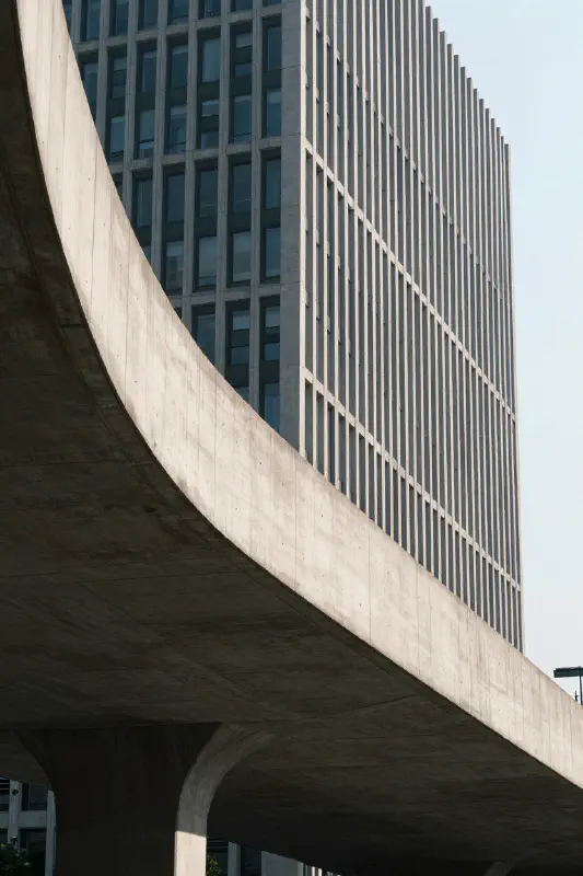 Telephoto Shot of a Curved Bridge and Architectural Building